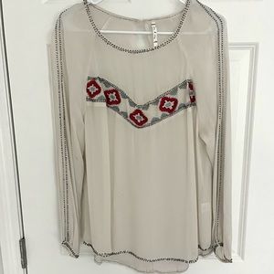 White blouse with pink and beading details